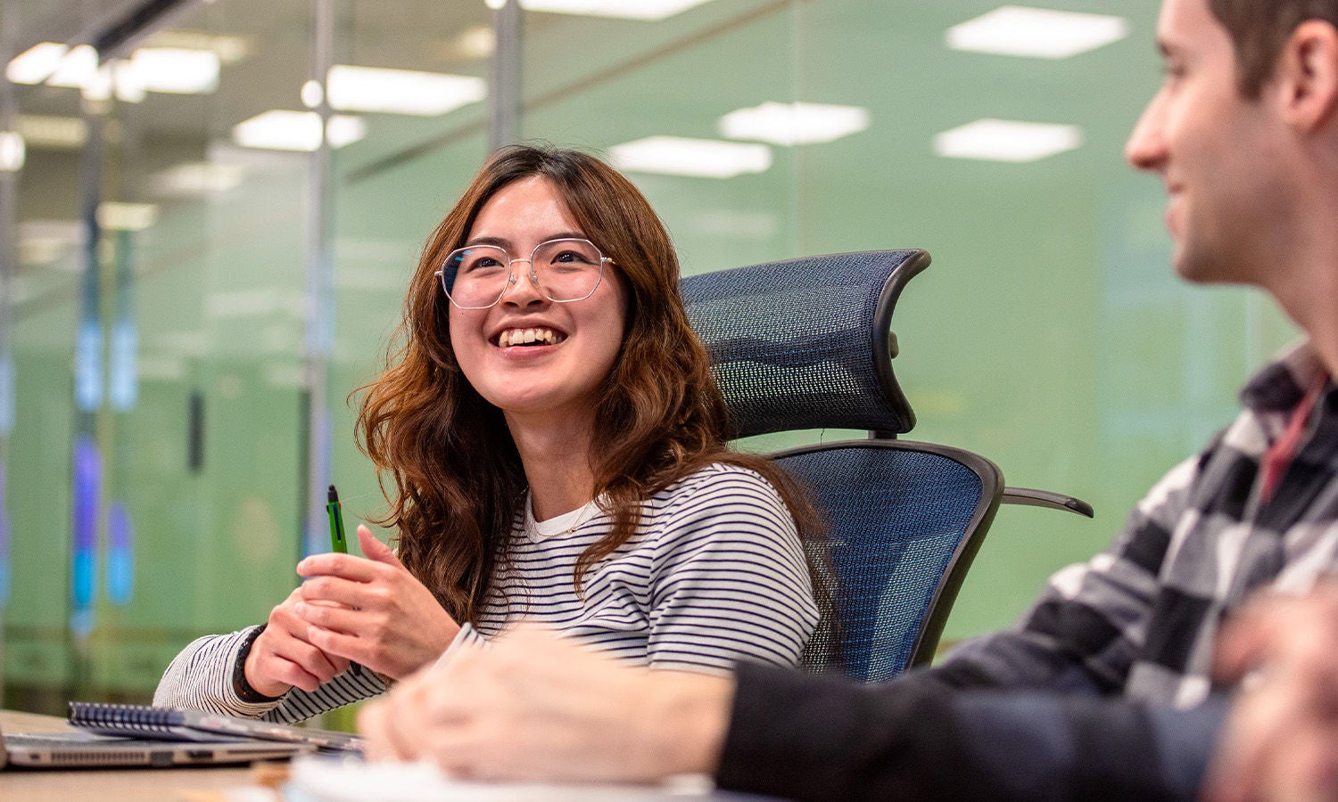Young woman smilingb office meeting room