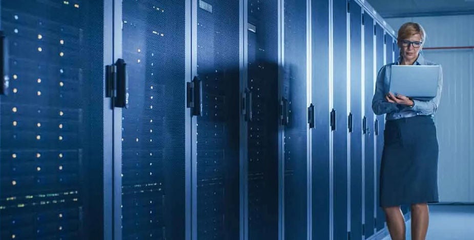 Woman on a laptop in a data center