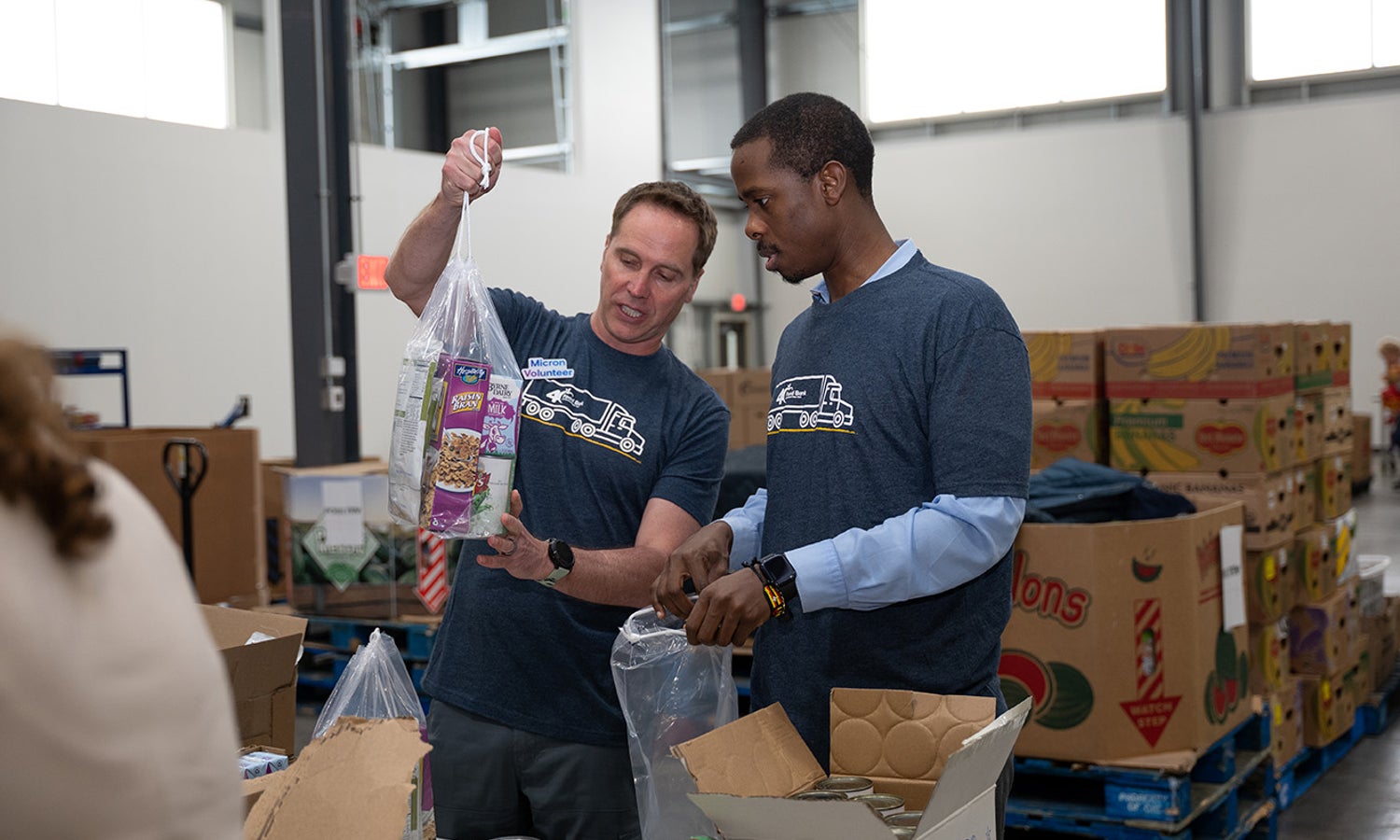 Volunteers sorting donated food and supplies at a community service event.