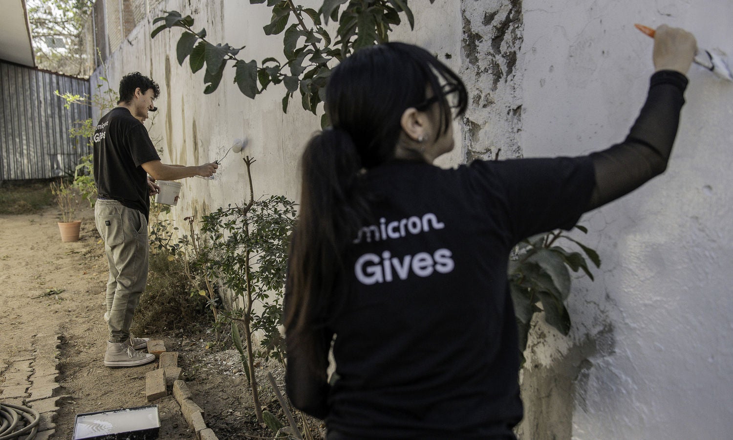 Volunteers painting a community wall during a service project