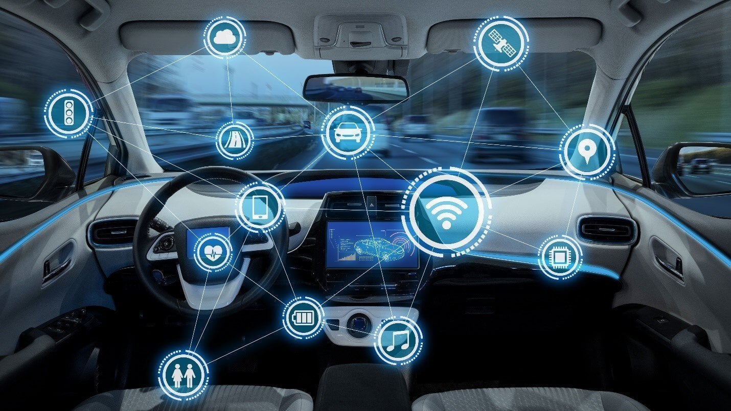 several cars on the road in background while showing the zoomed in image of one car interior
