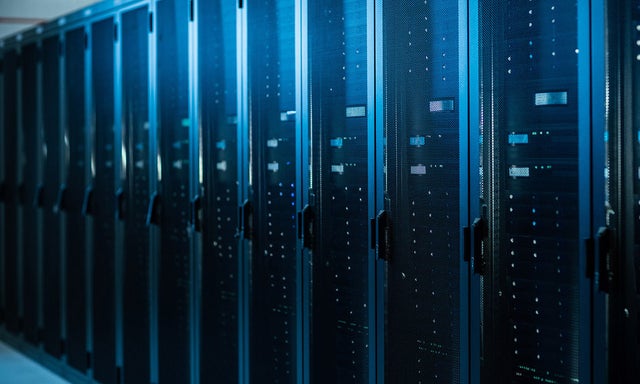 Rows of servers in a data center, in blue light