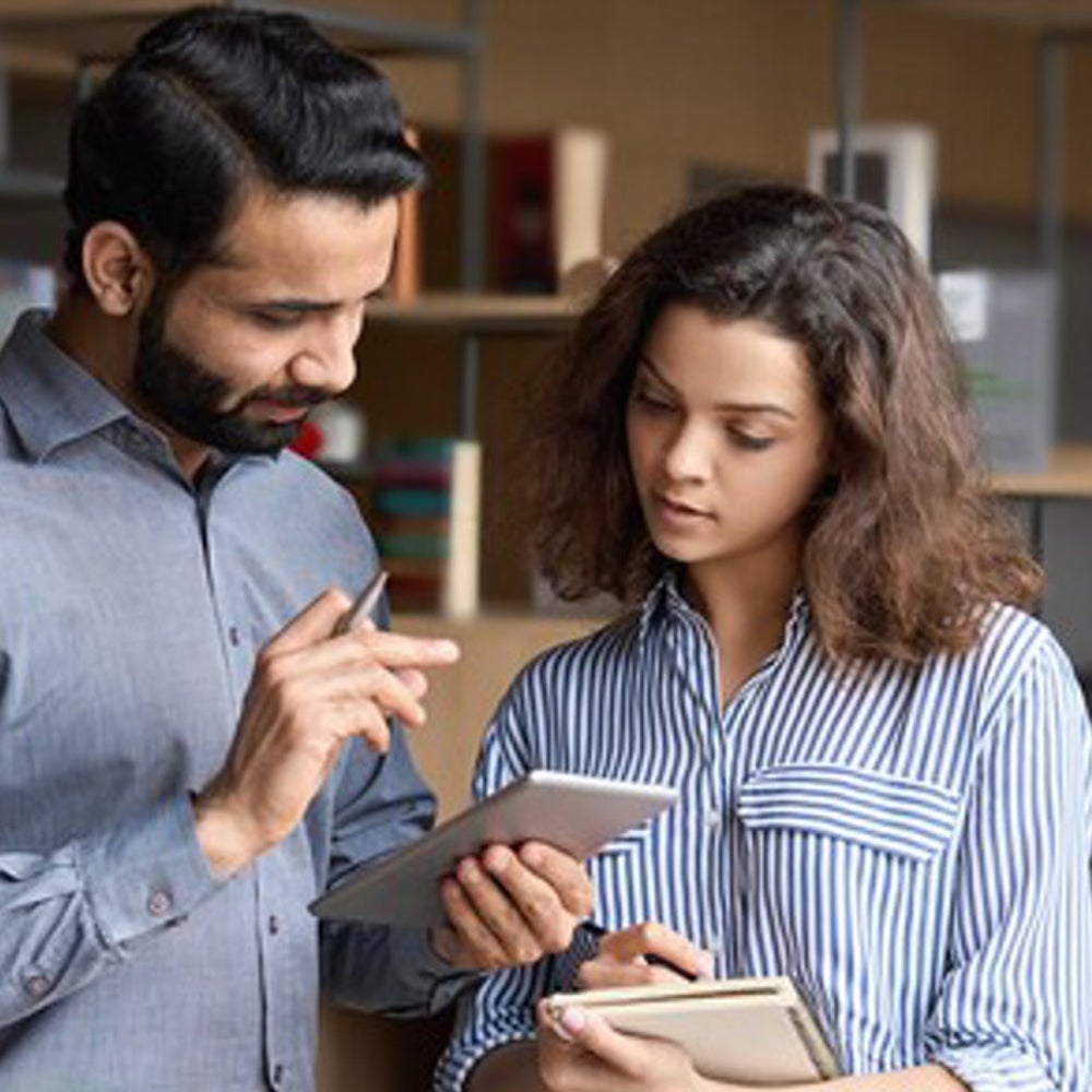 Co-workers looking at a mobile device