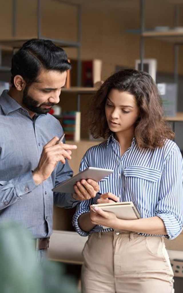 Co-workers looking at a mobile device