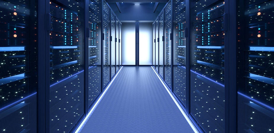 Long banks of data center storage on both side of a glowing door.