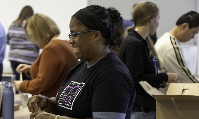 A group of Micron Gives volunteers assembling packets at an event