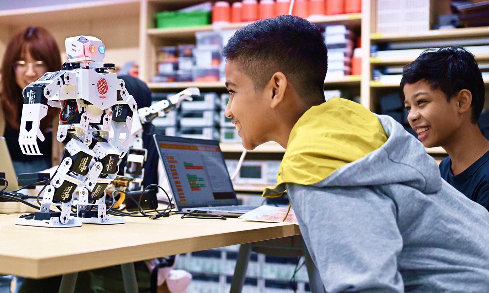 Students interacting with a classroom robotics project