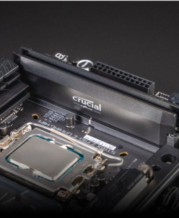 A macro shot of a motherboard with a Crucial DRAM installed.