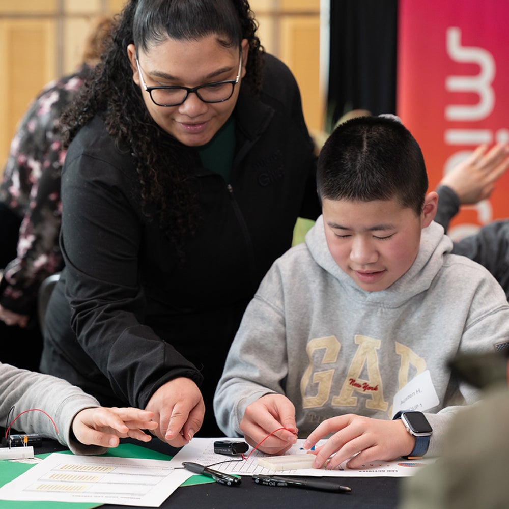 Instructor guiding students during a hands-on learning activity