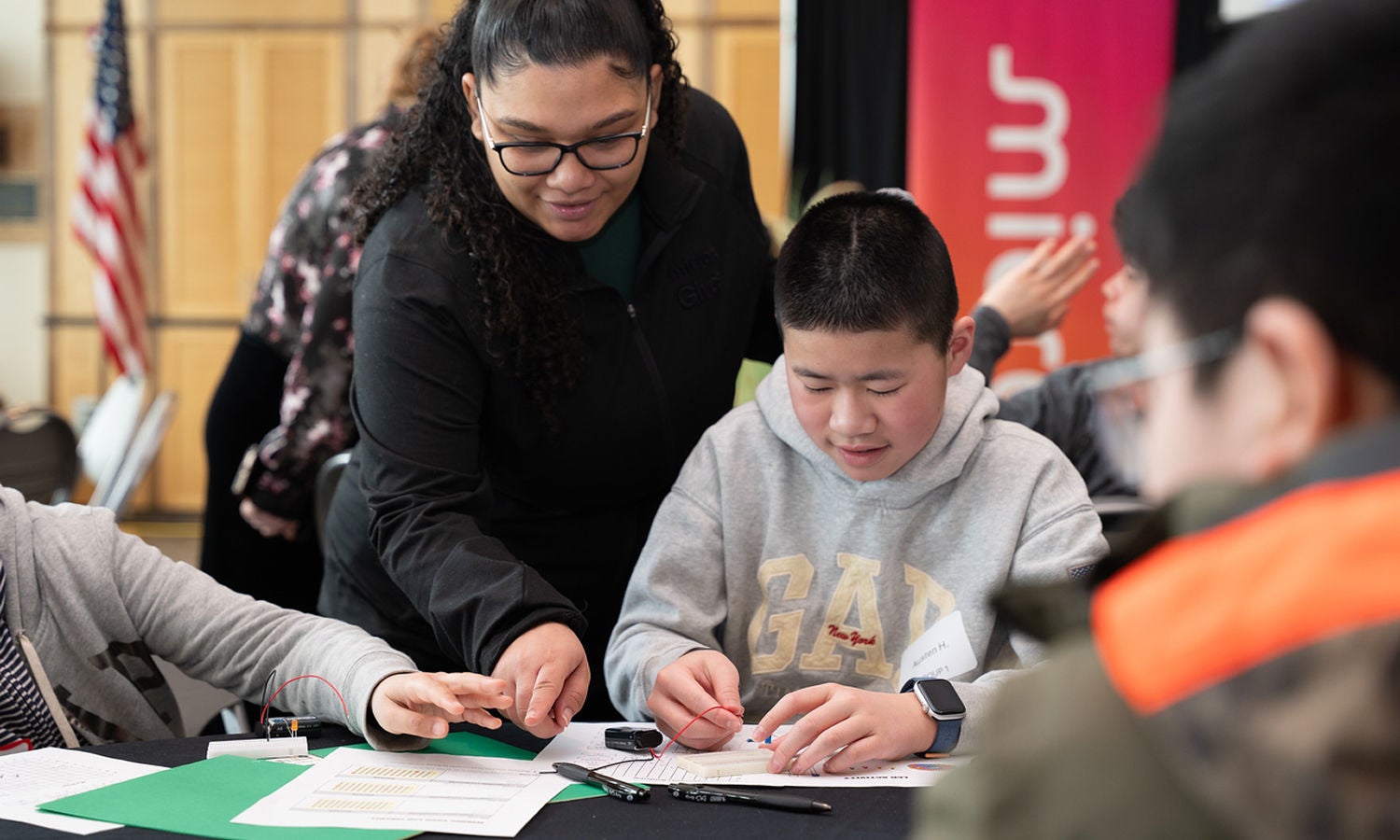 Instructor guiding students during a hands-on learning activity
