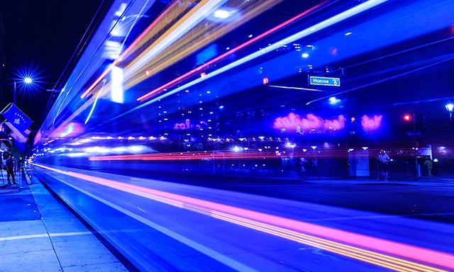 neon lights streaming down road