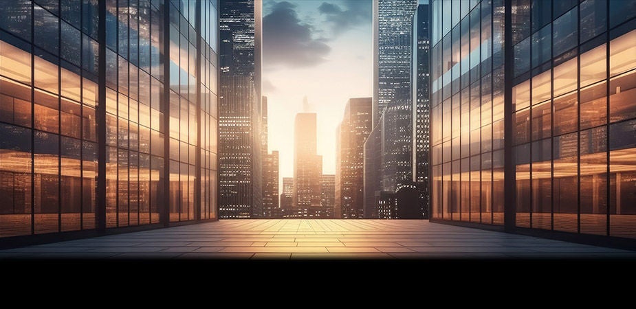 Looking between two glass buildings to a distant skyscraper during sunset