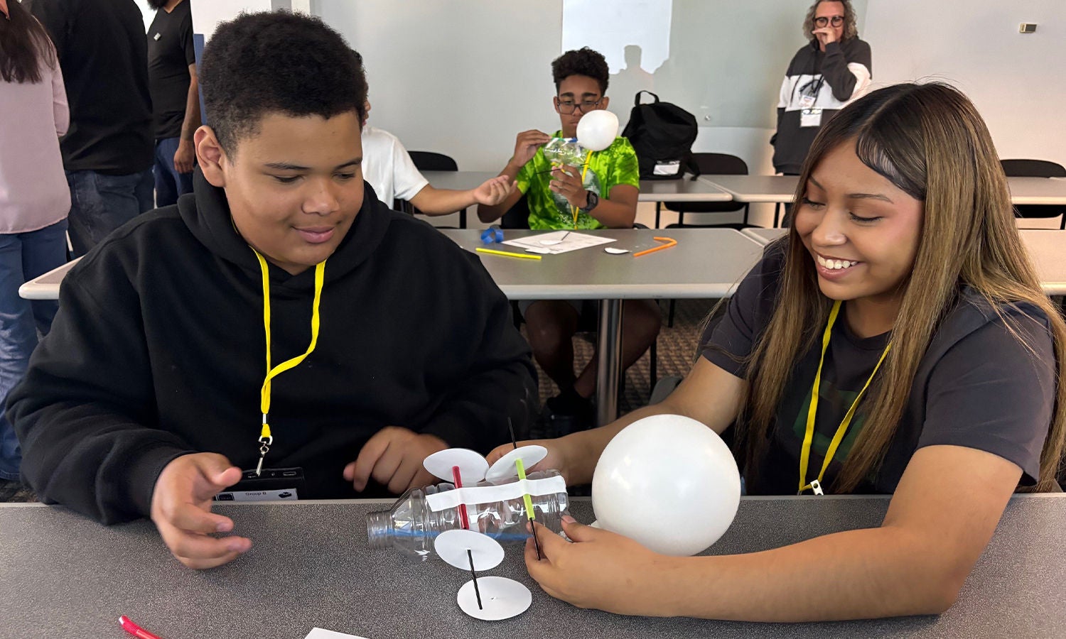 Students participating in a hands-on STEM activity with a balloon-powered project.
