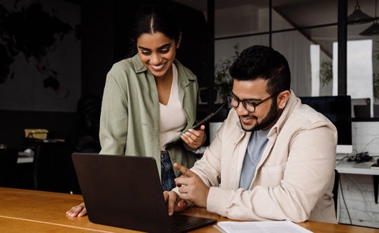 A team of women and men collaborate at work