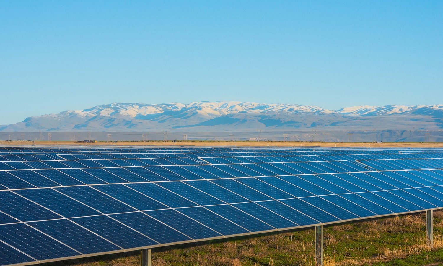Solar panels with mountains in the background