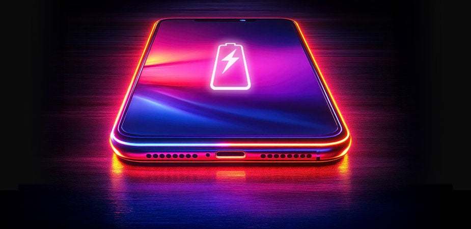 phone on table with battery and glowing in pink color