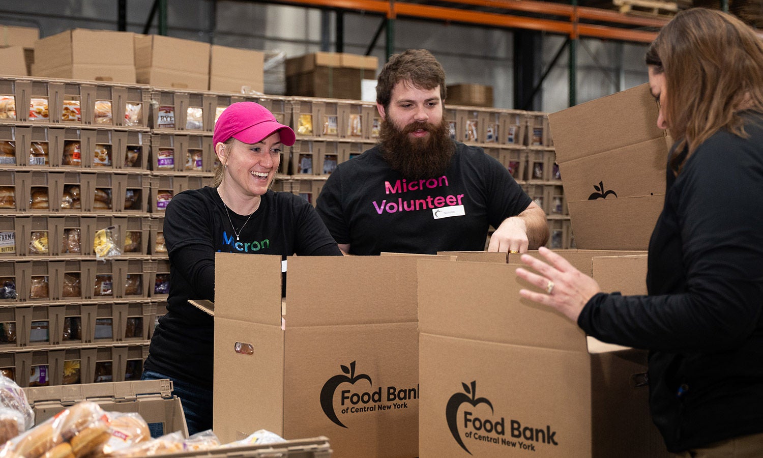 Micron volunteers packing food boxes at a food bank.