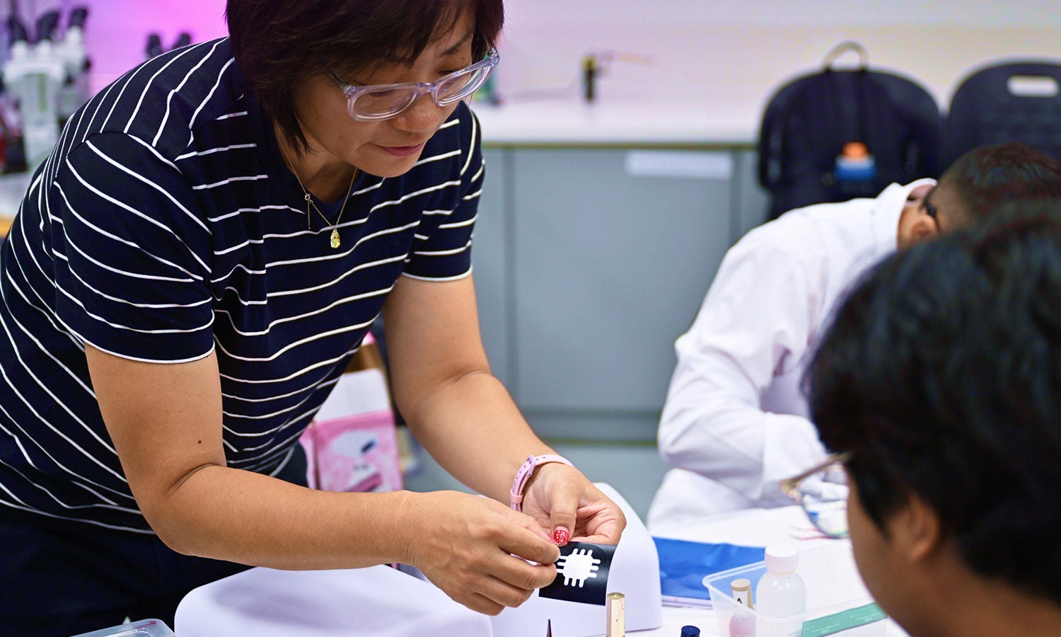 Educator guiding students during a hands-on STEM learning activity.