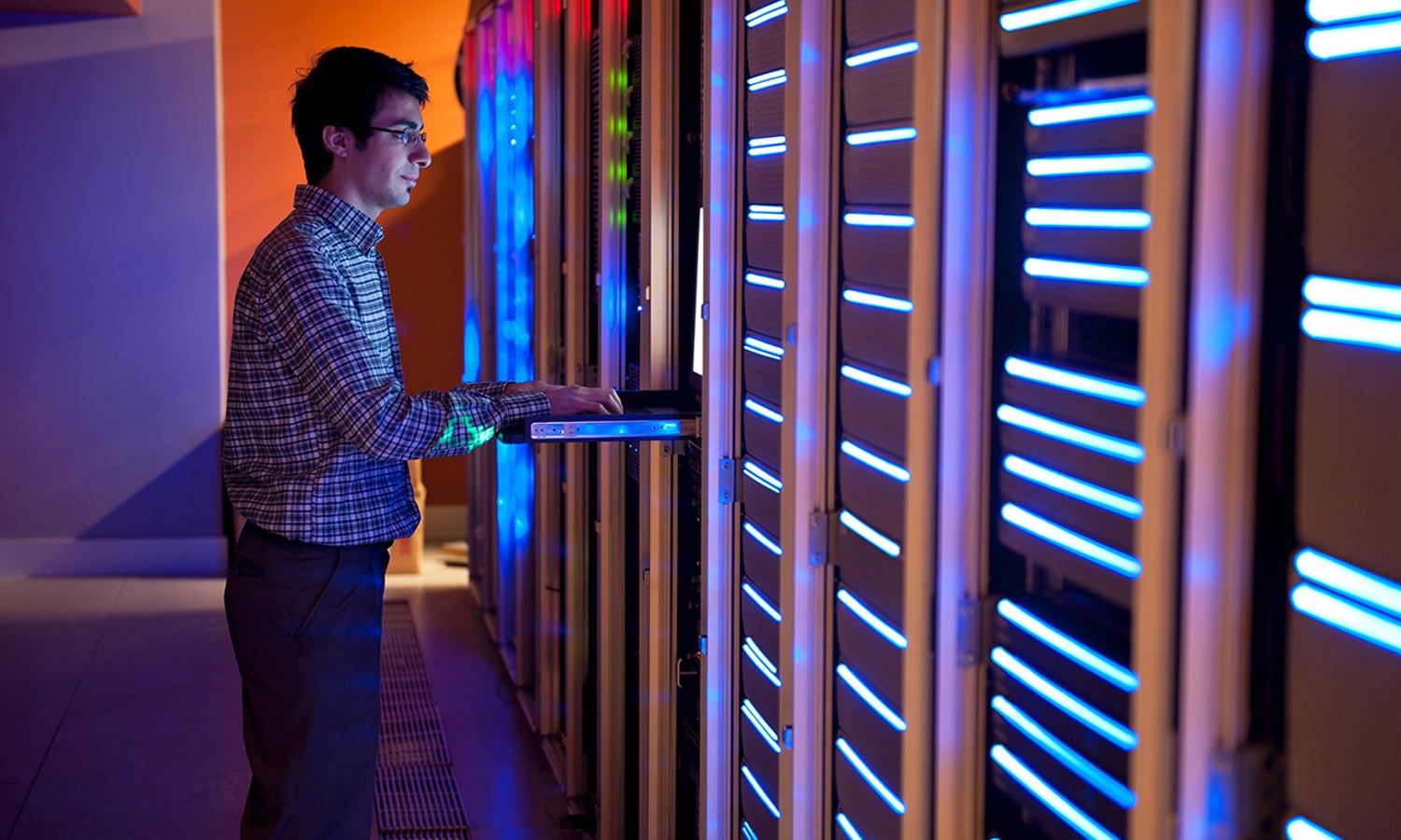 Man working in a darkened server room