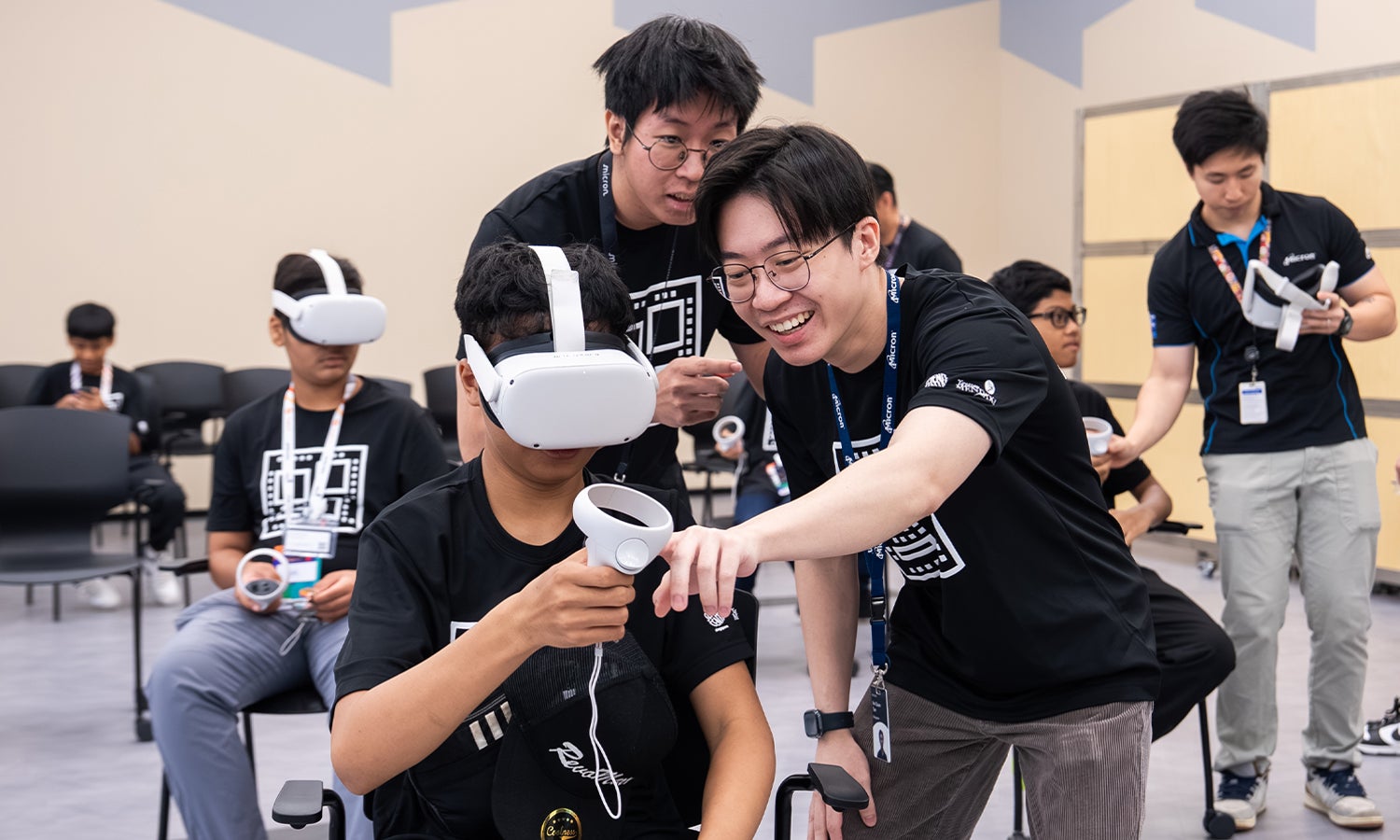 Students gathered around another student using a virtual reality headset