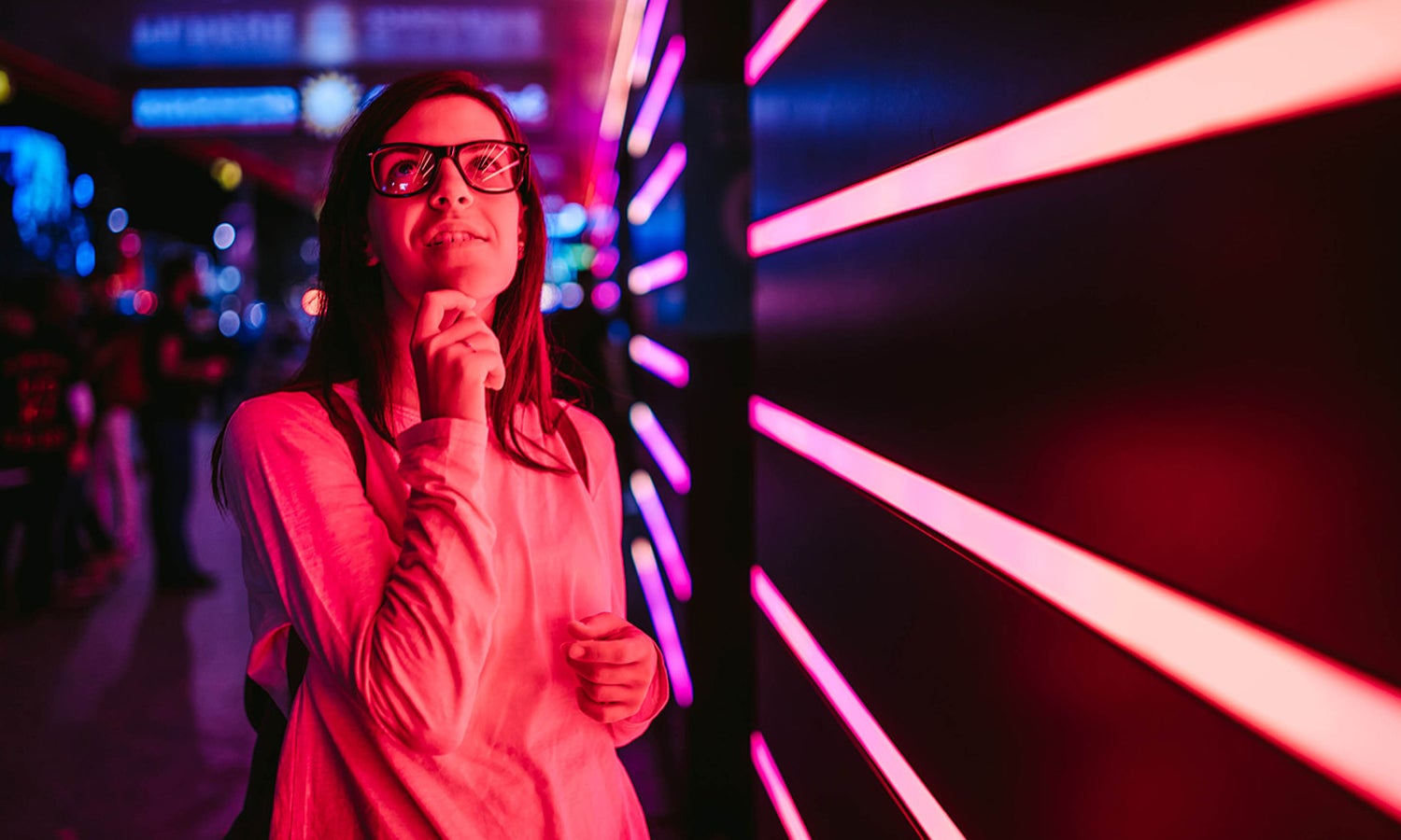 Women looking above with laser lights in the background