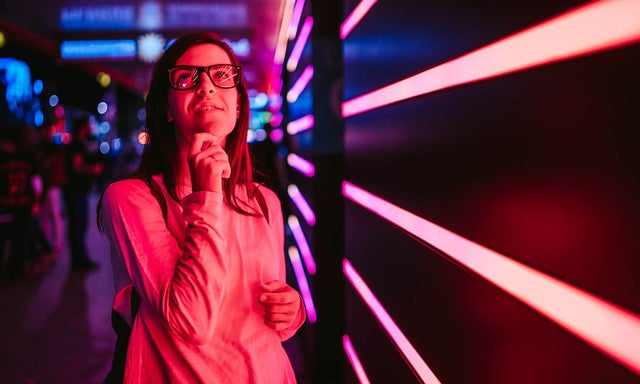 Women looking above with laser lights in the background