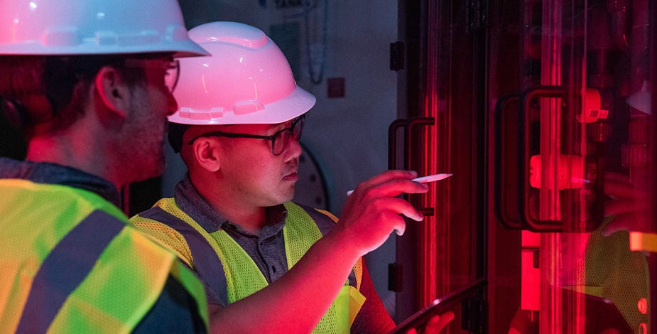 Two men inspecting equipment