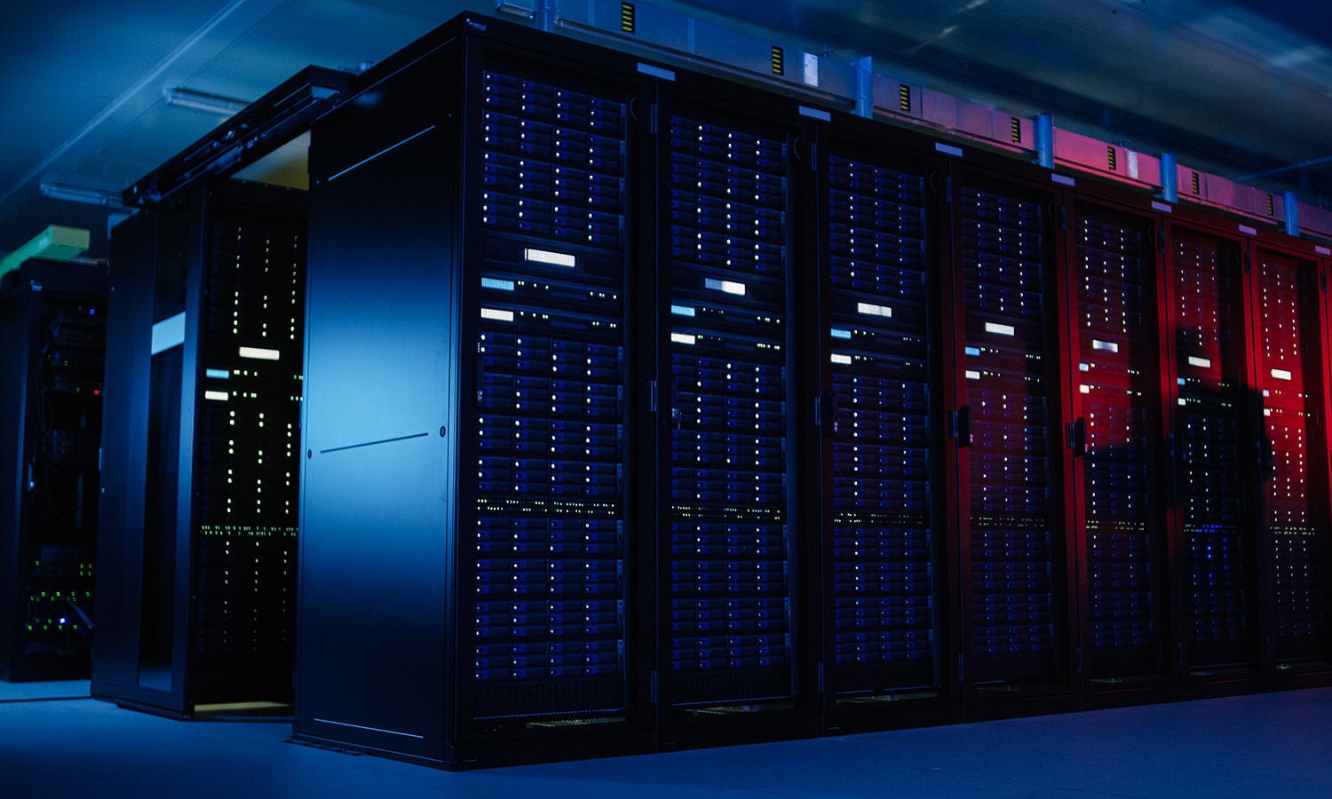 A bank of servers lit in white, purple, blue and red.