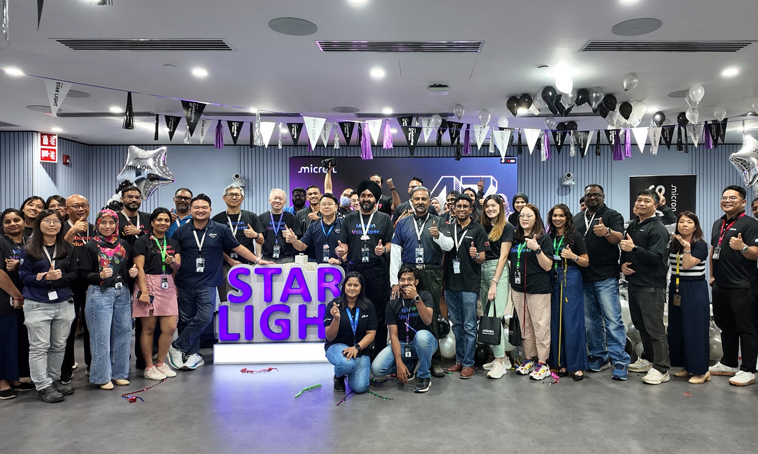 Group photo of Micron employees at a community event.