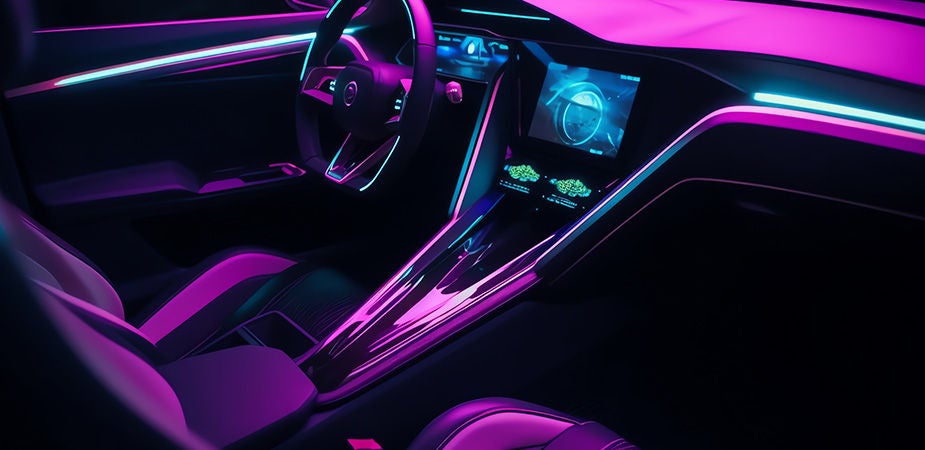 A glossy pnk, purple, teal, and blue lit vehicle interior.