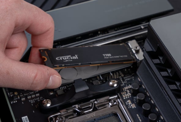 A Crucial T700 being slotted into a motherboard.
