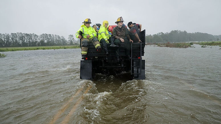 Emergency responders traveling through floodwaters during a disaster relief operation.