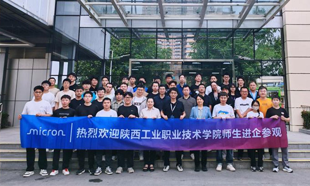 Students holding micron banner