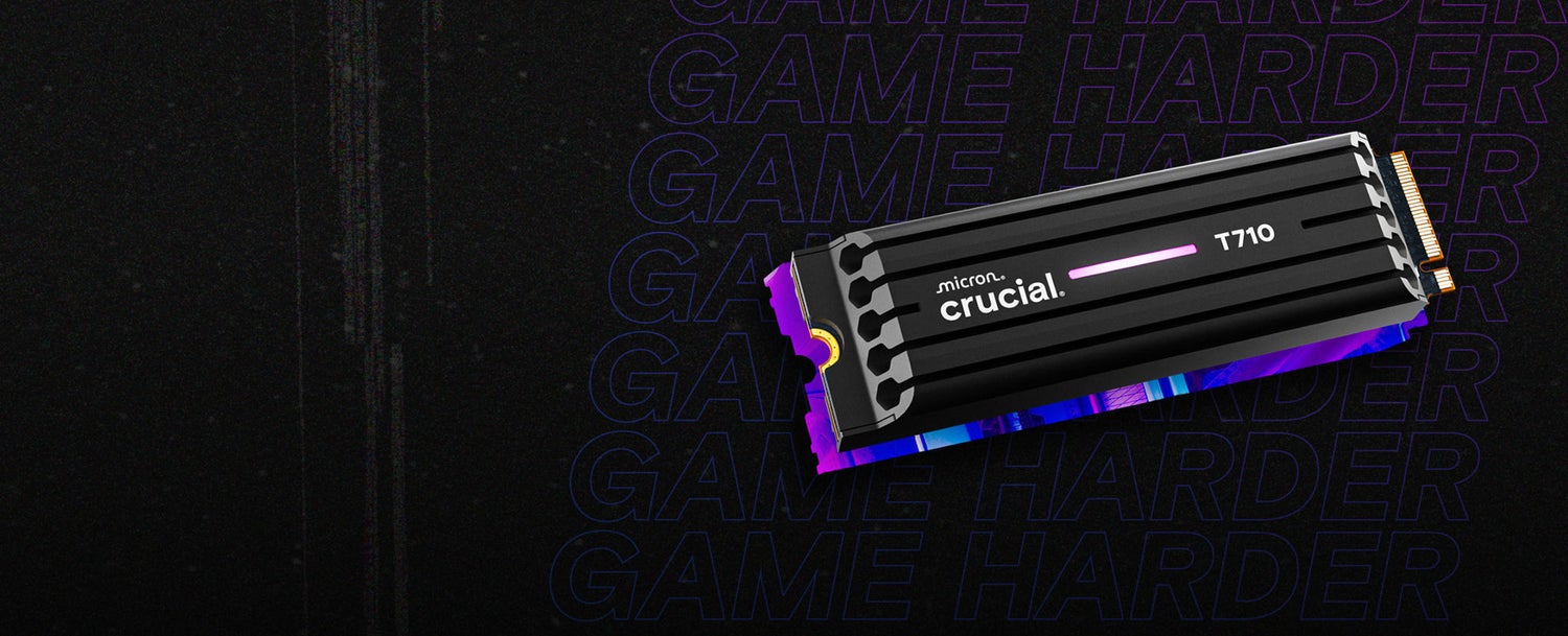 Crucial T710 NVMe SSD with a black heatsink and a glowing pink accent, displayed against a dark background featuring repeated text “GAME HARDER” in bold purple lettering