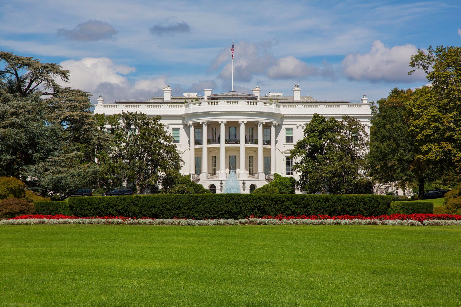 White House exterior with front lawn and trees.