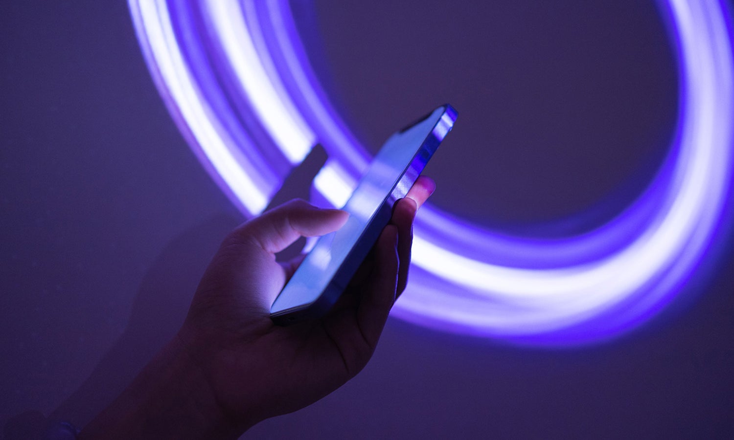 Hands working on a phone in the dark