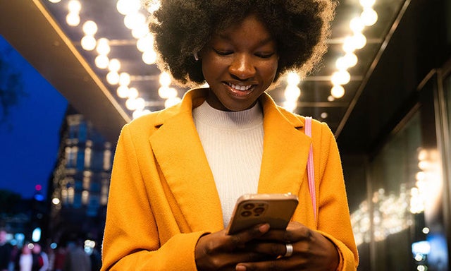 women looks delighted using the cell phone