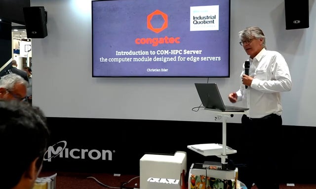 Man presenting at with Congatec logo on monitor in the background