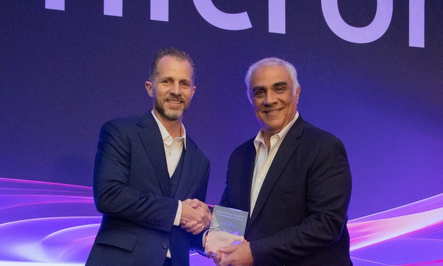 Kris Wilburn presenting the award to Maurice