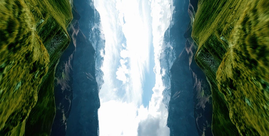 Mirrored mountain landscape with bright sky, creating a surreal vertical symmetry.​