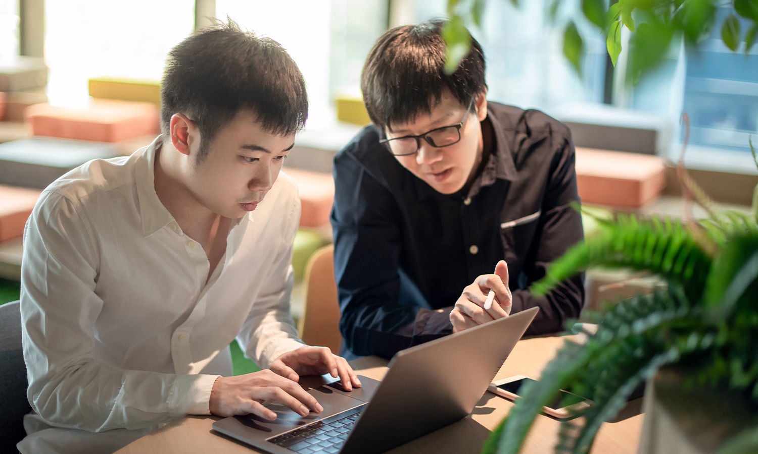 coworkers-reviewing-data-on-computer-screen