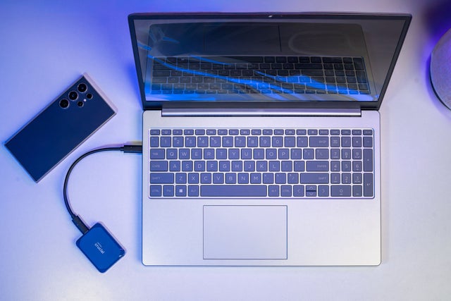 Image of Crucial SSD next to camera accessories.