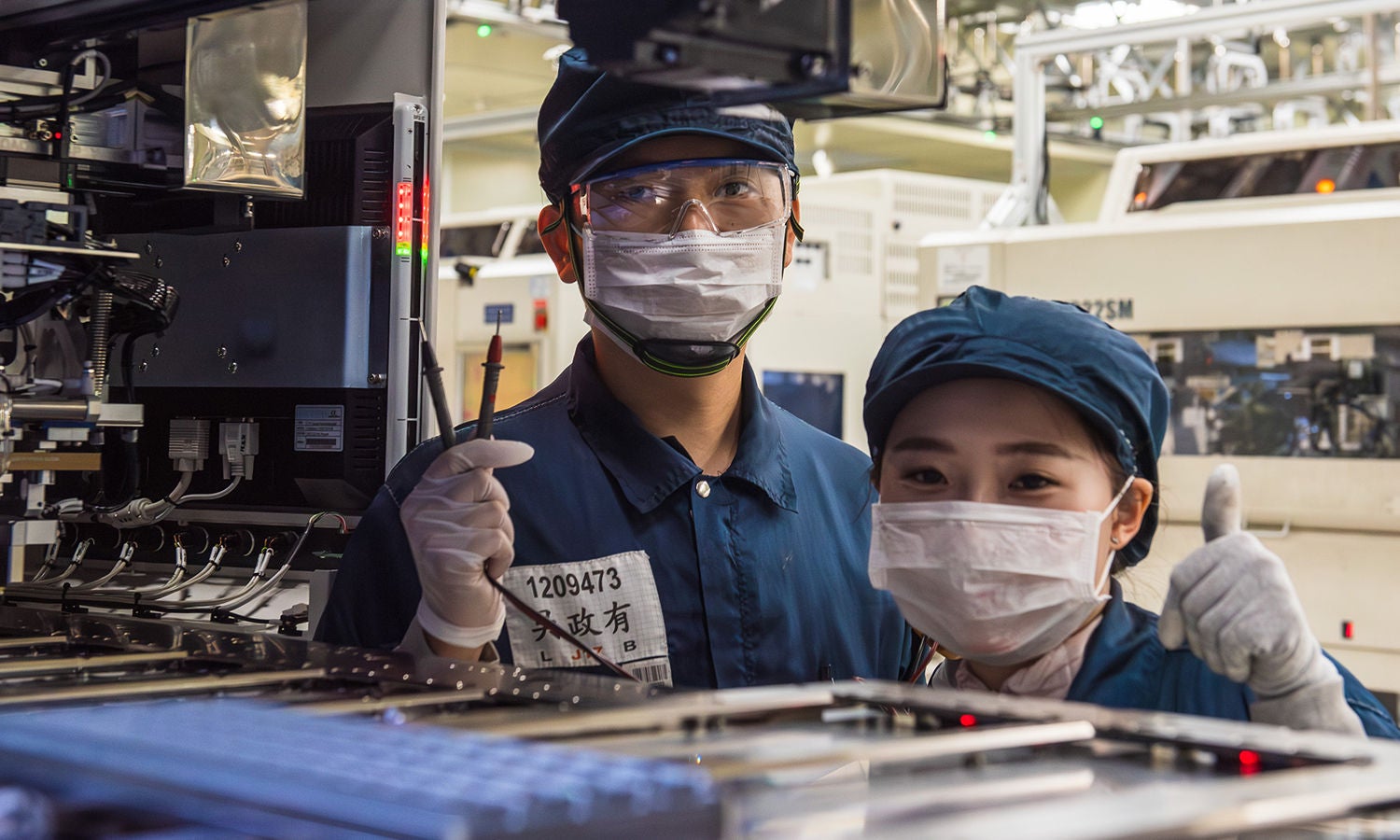 Two co-workers working at a laptop