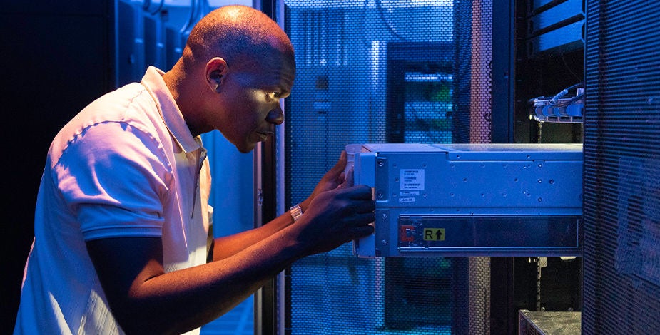 Micron worker inspecting a server rack in a data center