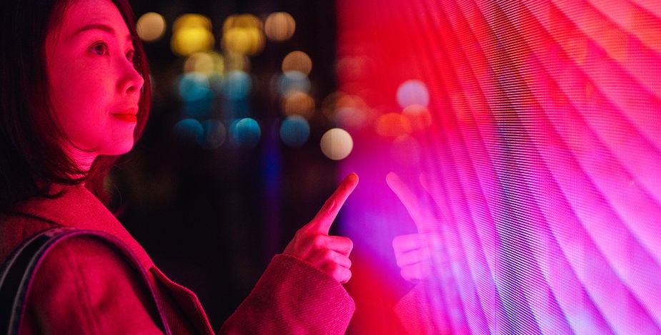 Woman touching pink neon