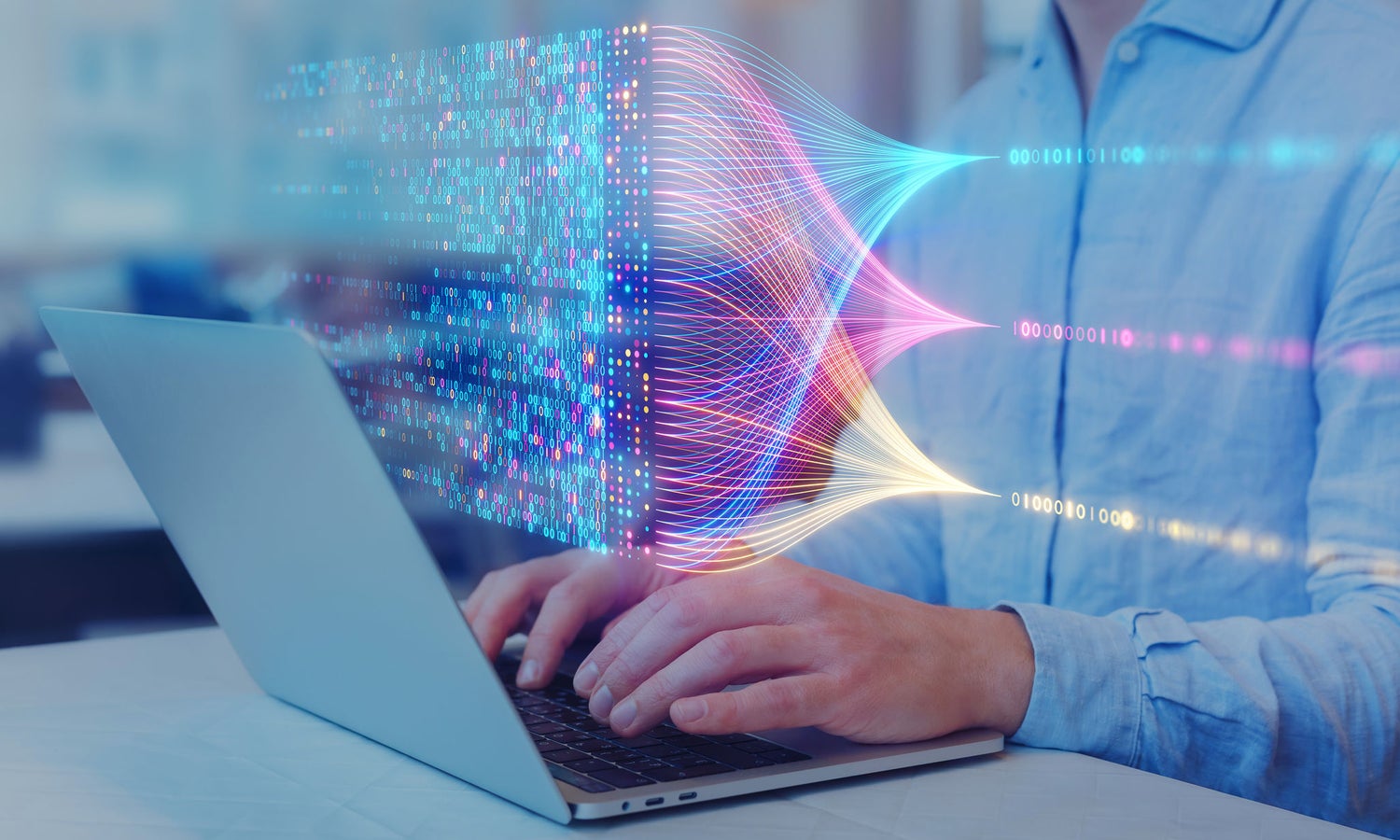 Person typing on laptop with digital data visualization overlay